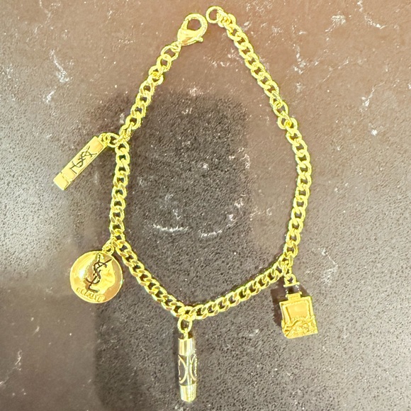Yves Saint Laurent Beautie Jewelry - Elegant Gold Charm Bracelet with Iconic Accents